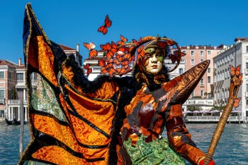 People in costume at the Venice carnival in front of the Madonna della Salute.