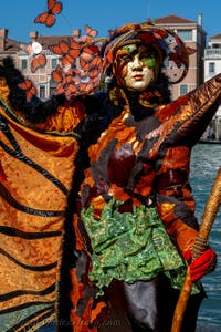 People in costume at the Venice carnival in front of the Madonna della Salute.