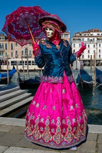 People in costume at the Venice carnival in front of the Madonna della Salute.