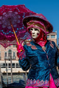 People in costume at the Venice carnival in front of the Madonna della Salute.