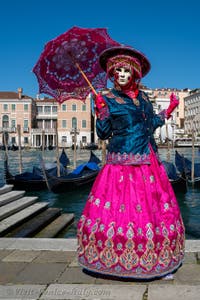 People in costume at the Venice carnival in front of the Madonna della Salute.