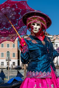 People in costume at the Venice carnival in front of the Madonna della Salute.