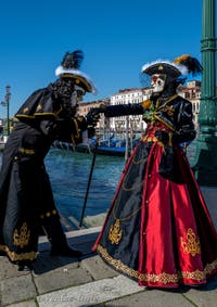 People in costume at the Venice carnival in front of the Madonna della Salute.