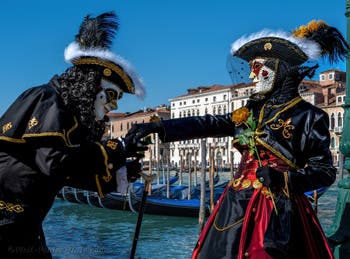 People in costume at the Venice carnival in front of the Madonna della Salute.