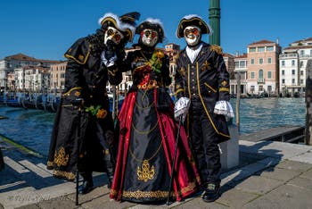 People in costume at the Venice carnival in front of the Madonna della Salute.