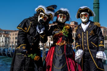 People in costume at the Venice carnival in front of the Madonna della Salute.