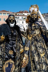 People in costume at the Venice carnival in front of the Madonna della Salute.