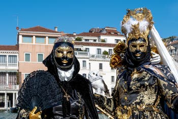 People in costume at the Venice carnival in front of the Madonna della Salute.