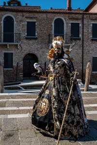 People in costume at the Venice carnival in front of the Madonna della Salute.