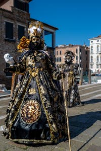 People in costume at the Venice carnival in front of the Madonna della Salute.