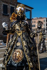 People in costume at the Venice carnival in front of the Madonna della Salute.