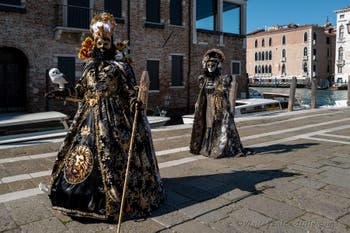 People in costume at the Venice carnival in front of the Madonna della Salute.