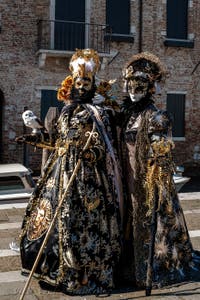 People in costume at the Venice carnival in front of the Madonna della Salute.