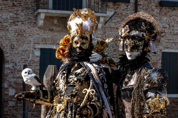 People in costume at the Venice carnival in front of the Madonna della Salute.