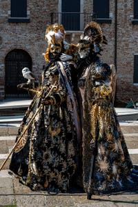 People in costume at the Venice carnival in front of the Madonna della Salute.