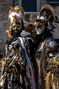 People in costume at the Venice carnival in front of the Madonna della Salute.