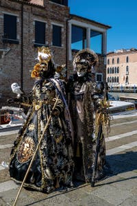 People in costume at the Venice carnival in front of the Madonna della Salute.