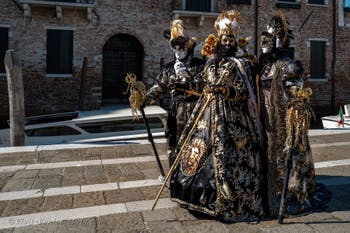 People in costume at the Venice carnival in front of the Madonna della Salute.