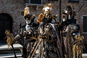 People in costume at the Venice carnival in front of the Madonna della Salute.