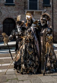 People in costume at the Venice carnival in front of the Madonna della Salute.