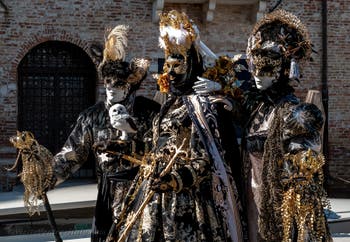 People in costume at the Venice carnival in front of the Madonna della Salute.