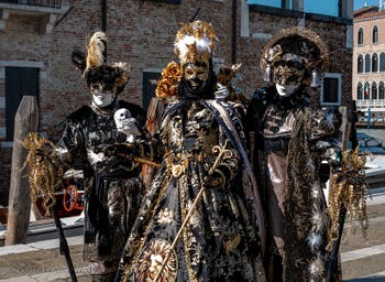 People in costume at the Venice carnival in front of the Madonna della Salute.