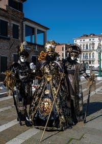 People in costume at the Venice carnival in front of the Madonna della Salute.