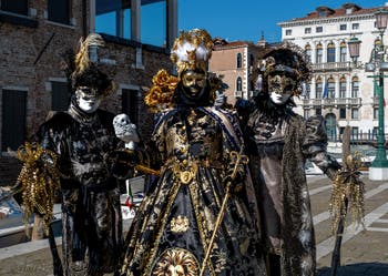 People in costume at the Venice carnival in front of the Madonna della Salute.