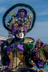 People in costume at the Venice carnival in front of the Madonna della Salute.