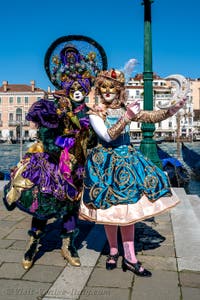 People in costume at the Venice carnival in front of the Madonna della Salute.