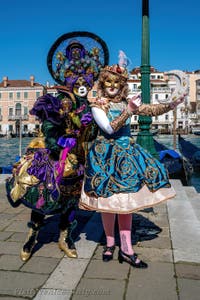 People in costume at the Venice carnival in front of the Madonna della Salute.