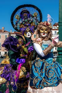 People in costume at the Venice carnival in front of the Madonna della Salute.