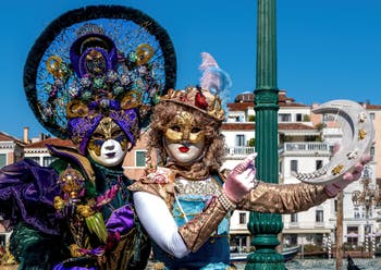 People in costume at the Venice carnival in front of the Madonna della Salute.