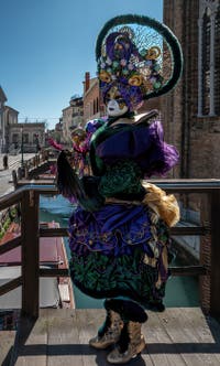 People in costume at the Venice carnival in front of the Madonna della Salute.