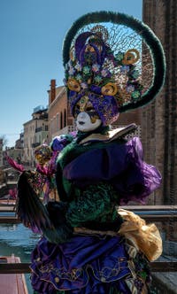 People in costume at the Venice carnival in front of the Madonna della Salute.