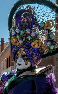 People in costume at the Venice carnival in front of the Madonna della Salute.