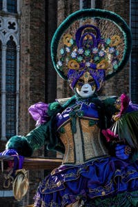 People in costume at the Venice carnival in front of the Madonna della Salute.