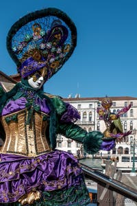 People in costume at the Venice carnival in front of the Madonna della Salute.