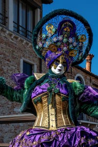 People in costume at the Venice carnival in front of the Madonna della Salute.