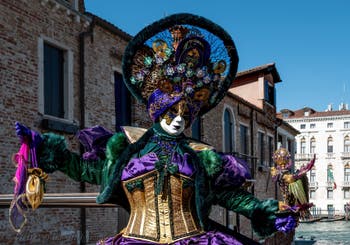 People in costume at the Venice carnival in front of the Madonna della Salute.