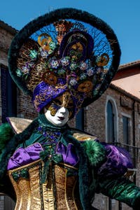 People in costume at the Venice carnival in front of the Madonna della Salute.