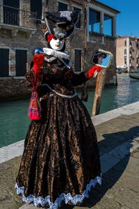 People in costume at the Venice carnival in front of the Madonna della Salute.