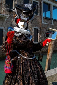 People in costume at the Venice carnival in front of the Madonna della Salute.