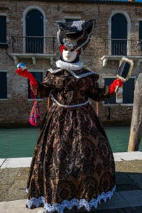 People in costume at the Venice carnival in front of the Madonna della Salute.