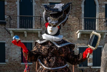 People in costume at the Venice carnival in front of the Madonna della Salute.