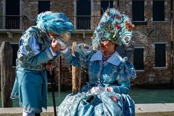 People in costume at the Venice carnival in front of the Madonna della Salute.