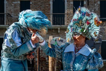 People in costume at the Venice carnival in front of the Madonna della Salute.