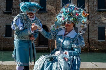 People in costume at the Venice carnival in front of the Madonna della Salute.