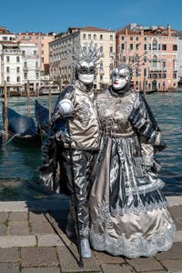 People in costume at the Venice carnival in front of the Madonna della Salute.