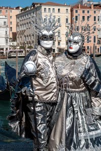 People in costume at the Venice carnival in front of the Madonna della Salute.